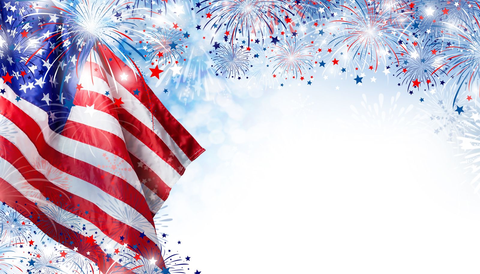 American flag with fireworks bursting behind it